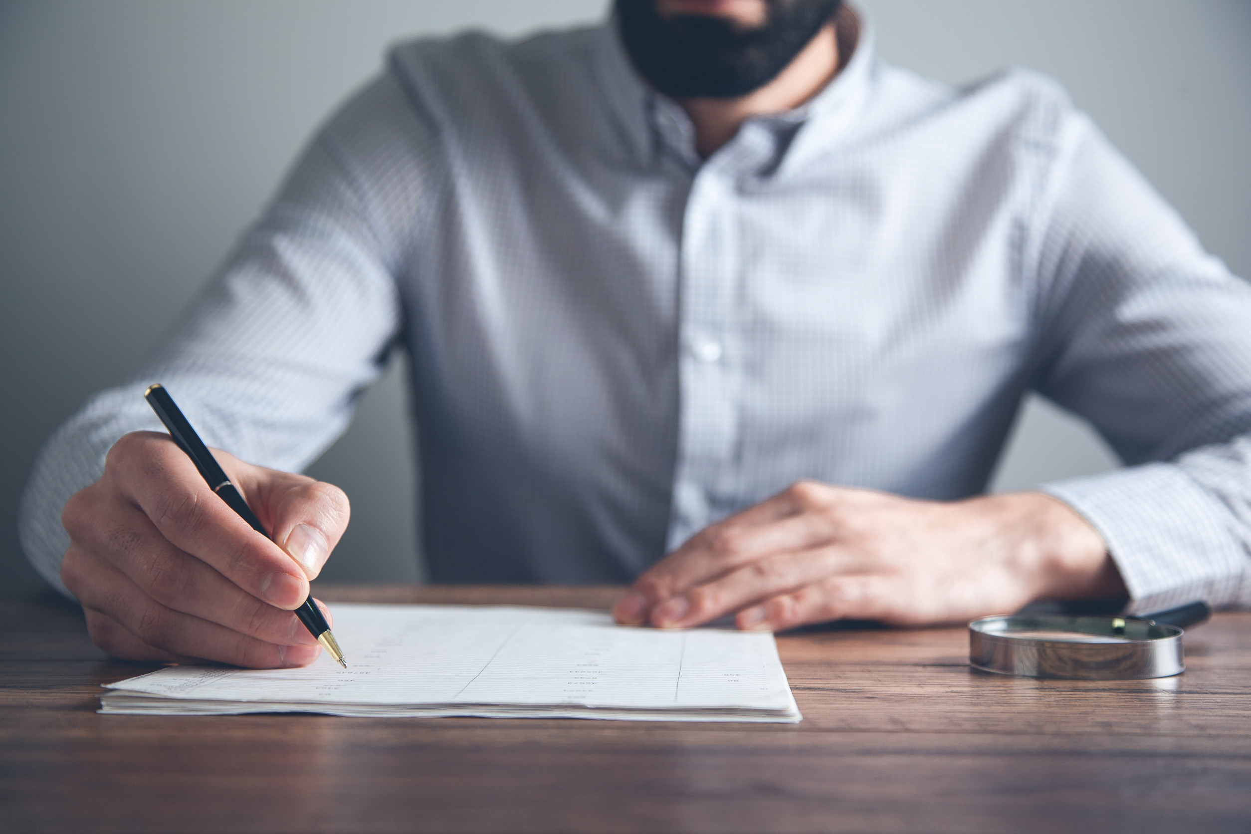 man hand document with magnifier on desk man hand document with magnifier on desk